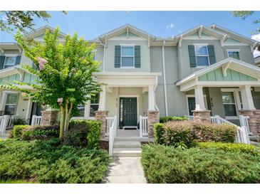 Inviting two-story townhouse with fresh landscaping and a welcoming front porch at 8164 Wood Sage Dr, Winter Garden, FL 34787