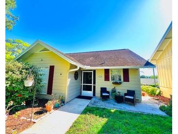 Charming single-story home with a cozy front porch, lush landscaping, and inviting curb appeal at 1034 Villa Ln # 18, Apopka, FL 32712
