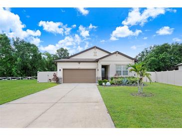 Charming single-story home with a well-manicured lawn and a two-car garage at 2491 Wadeview Loop, St Cloud, FL 34769