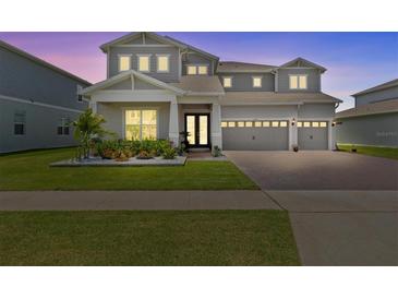 Charming two-story home featuring a three-car garage and beautifully landscaped front yard at 3179 Sailing Pier Ave, Winter Garden, FL 34787