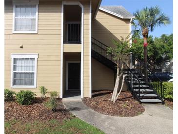 Inviting apartment complex featuring stairs leading to the second floor entrance with a small palm tree at 1019 S Hiawassee Rd # 3811, Orlando, FL 32835
