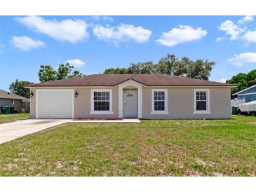 Charming single-story home featuring a well-maintained lawn and attached one-car garage at 3313 Buckland St, Deltona, FL 32738