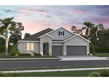 Charming two-story home with stone accents, a three-car garage and manicured landscaping at 3492 Lemon Button Ter, Apopka, FL 32712