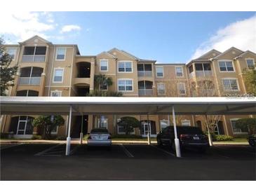Apartment building with multiple stories and covered parking at 6434 Cava Alta Dr # 401, Orlando, FL 32835