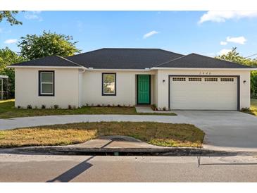 Charming one-story home boasts a teal front door and a well-manicured lawn at 2446 Greenway, Sanford, FL 32771