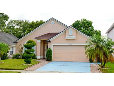 Charming single-Gathering home featuring manicured lawn and a two-car garage at 12406 Beacontree Way, Orlando, FL 32837