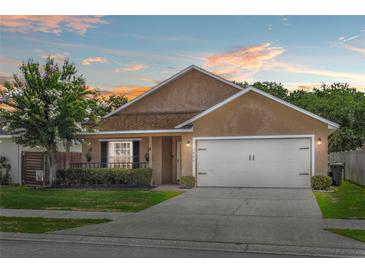 Charming single-story home featuring a well-manicured lawn and a two-car garage at 2980 Cool Breeze Cir, St Cloud, FL 34769