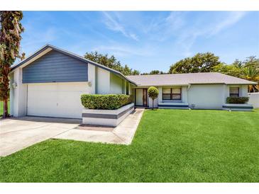 Charming single-story home featuring a well-manicured lawn and neutral tones at 5130 Sun Palm Dr, Windermere, FL 34786