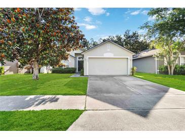 Charming single-story home features a well-manicured lawn and a two-car garage at 16603 Corner Lake Dr, Orlando, FL 32820
