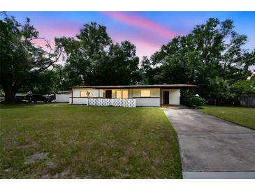 Charming single-story home featuring a well-manicured lawn and cozy front porch area at 206 Gerry Dr, Altamonte Springs, FL 32714