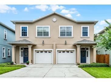 Inviting exterior of a two-story townhome with a neutral color scheme and a two-car garage at 336 E Kaley St, Orlando, FL 32806