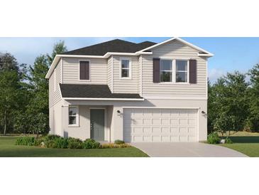 Charming two-story home with a attached two-car garage, well-maintained lawn and neutral toned siding at 3535 Kimbrough Dr, Lake Wales, FL 33859