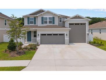 Charming two-story home with three-car garage, landscaped yard and covered entryway at 3990 Bannock Ave, Tavares, FL 32778