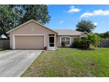 Charming single-story home features an attached garage, well-maintained lawn, and delightful landscaping at 144 Fort Smith Blvd, Deltona, FL 32738