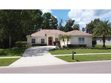 Charming single-story home with a well-manicured lawn and a welcoming driveway at 1679 Shadowmoss Cir, Lake Mary, FL 32746
