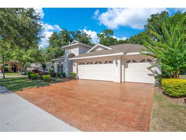 Charming home featuring a three-car garage and beautifully landscaped front yard at 216 Homestretch Blvd, Deland, FL 32724