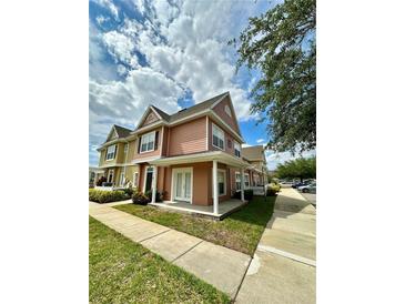 Charming townhome featuring a covered front porch and well-maintained landscaping at 2200 San Vittorino Cir # 102, Kissimmee, FL 34741