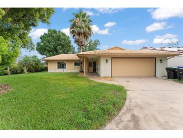 Charming single-story home featuring a two-car garage, mature landscaping, and a classic tiled roof at 5237 Gateway Ave, Orlando, FL 32821