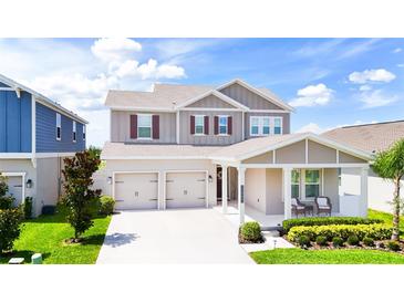Beautiful two-story home featuring a symmetrical facade, a two-car garage, and a manicured front yard at 13993 Title Way, Winter Garden, FL 34787