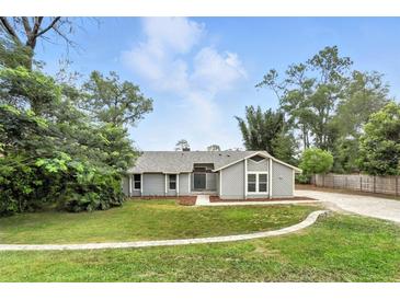 Charming single-story home with a well-manicured lawn and inviting curb appeal at 1850 North St, Longwood, FL 32750