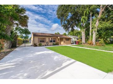 Charming single-story home featuring a well-manicured lawn and a long driveway at 2918 E Central Blvd, Orlando, FL 32803