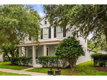 Charming two-story home with a welcoming front porch and well-manicured landscaping at 10117 Sweetleaf St, Orlando, FL 32827