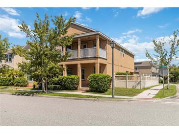 Charming two-story home features a balcony, well-maintained landscaping, and a welcoming facade at 12255 Joshua Tree Trl, Windermere, FL 34786