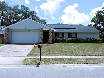 Charming single-story home features a stone accent facade, updated roof and well-manicured lawn at 1361 Sterling Oaks Dr, Casselberry, FL 32707