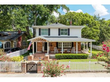Charming two-story home with a welcoming front porch, brick accents, and a lovely landscaped yard at 3 W Yale St, Orlando, FL 32804