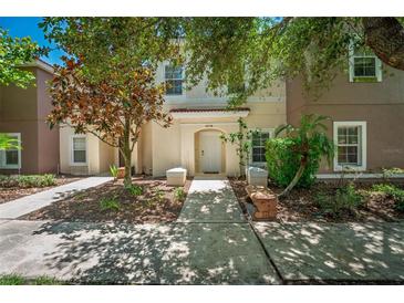 Inviting townhome exterior with a well-manicured lawn and covered entrance, creating great curb appeal at 4558 Baleno Ln, Kissimmee, FL 34746