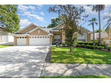 Charming home featuring a well-manicured lawn, mature landscaping, and a spacious three-car garage at 538 Majestic Oak Dr, Apopka, FL 32712