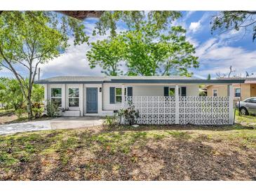 Charming single-story home with a well-maintained front yard and distinctive concrete privacy wall at 7601 Aviano Ave, Orlando, FL 32819