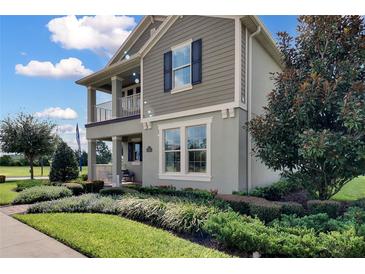 Charming two-story home with a covered porch, well-maintained landscaping, and a mix of textures at 11158 Hollow Bay Dr, Winter Garden, FL 34787