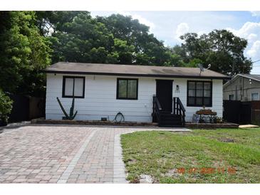 Charming single-story home with brick driveway, a cozy front yard, and a simple yet inviting facade at 233 N Hudson St, Orlando, FL 32835