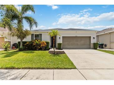 Charming single-Gathering home with a well-manicured lawn, a two-car garage, and tropical landscaping at 12084 Sumter Dr, Orlando, FL 32824