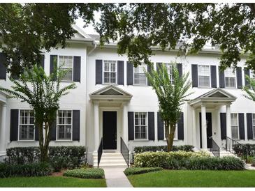 Attractive townhome exterior featuring lush landscaping and black shutters at 1649 Lake Baldwin Ln, Orlando, FL 32814