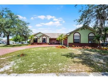 Charming single-story home with a spacious front yard and mature landscaping at 4523 Wyndcliff Cir, Orlando, FL 32817