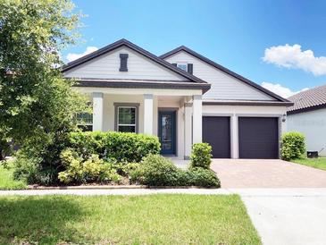 Charming one-story home with a well-maintained lawn and a two-car garage, perfect for modern living at 15071 Guava Bay Dr, Winter Garden, FL 34787