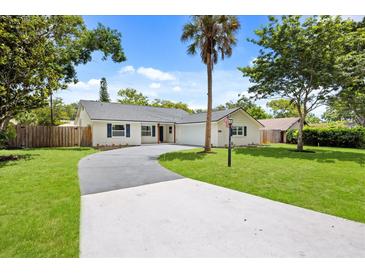 Charming single story home with a winding driveway, lawn, mature trees, and updated paint at 2089 Sunderland Rd, Maitland, FL 32751