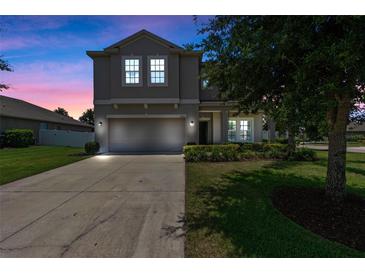Charming two-story home featuring a well-manicured lawn, driveway, and attached two-car garage at 2560 Hayden Valley Street, Apopka, FL 32703