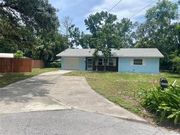 Charming single-story home with a long driveway and well-maintained lawn at 3695 Dale Ct, Mount Dora, FL 32757