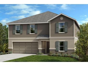 Charming two-story home with gray siding, shutters, a well-manicured lawn, and an attached garage at 3820 Elk Bluff Rd, St Cloud, FL 34772