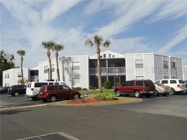 Cozy two-story condo building with beautiful palm trees and parking at 3863 Atrium Dr # L-6, Orlando, FL 32822