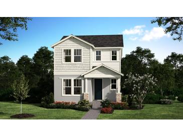 Charming two-story home featuring white siding, well-manicured lawn, and welcoming front porch, perfect for modern living at 396 Oak Flat Aly, Groveland, FL 34736