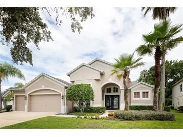 Charming single-Gathering home with lush landscaping, manicured lawn, and a welcoming front entrance at 697 Broadoak Loop, Sanford, FL 32771