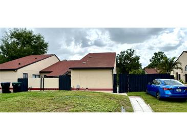 Cozy single-story home featuring a well-kept lawn and a fenced yard for privacy and security at 761 Golden Sunshine Cir, Orlando, FL 32807