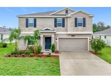 Charming two-story home with landscaped yard, beautiful lawn and a two car garage at 16436 Fernridge St, Clermont, FL 34714