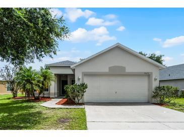 Charming single-story home features a well-maintained lawn and inviting curb appeal at 5671 Sycamore Canyon Dr, Kissimmee, FL 34758