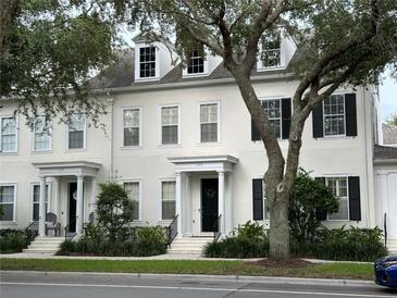 Charming two-story townhome with black shutters, dormer windows and welcoming front entrance at 1126 Celebration Ave, Celebration, FL 34747