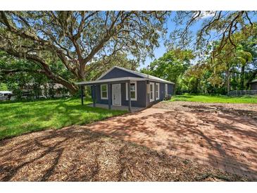 Charming single-story home featuring a brick driveway, well-maintained lawn, and mature trees at 1503 Granite State Ct, Mount Dora, FL 32757